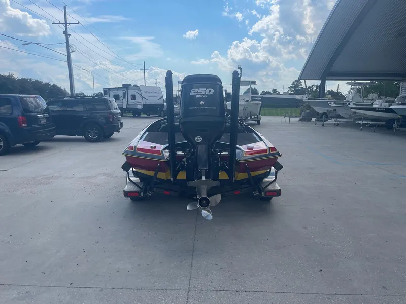 Slide: The Image of 2013 Bullet 21 XRS boat with a 250 HP engine, parked outdoors. - 3