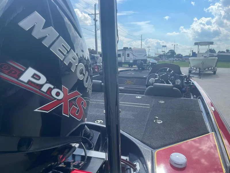 Slide: The Image of 2013 Bullet 21 XRS boat with Mercury Pro XS engine in a parking lot. - 8