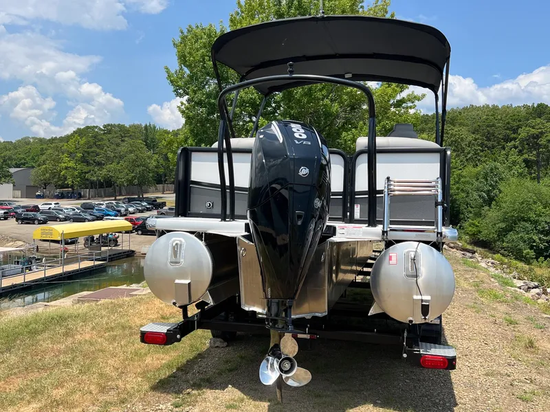 Slide: The Image of 2024 Premier 230 Sunsation RE pontoon boat with outboard motor, docked on a sunny day. - 5