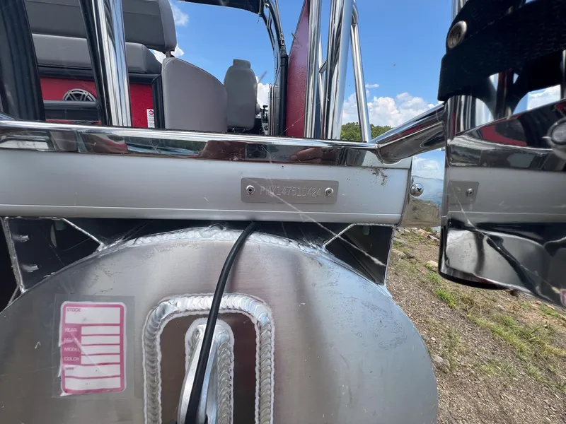 Slide: The Image of 2024 Premier 250 SunSation RF pontoon boat rear view with stainless steel details. - 11