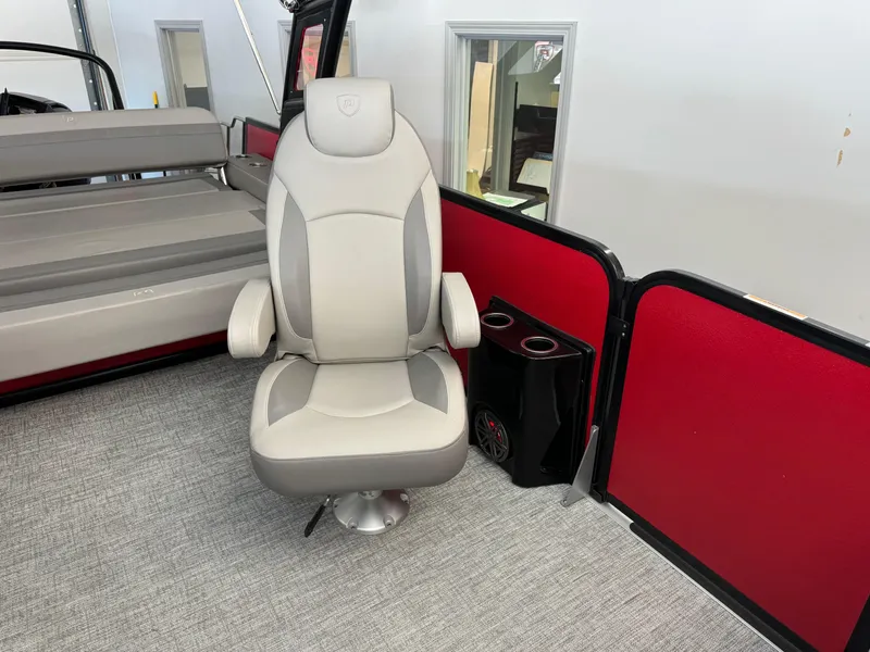 Slide: The Image of 2024 Premier 250 SunSation RL boat interior with plush captain's chair and red paneling. - 15