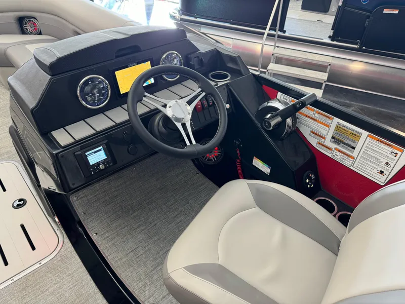 Slide: The Image of 2024 Premier 250 SunSation RL boat interior with modern dashboard and steering wheel. - 16