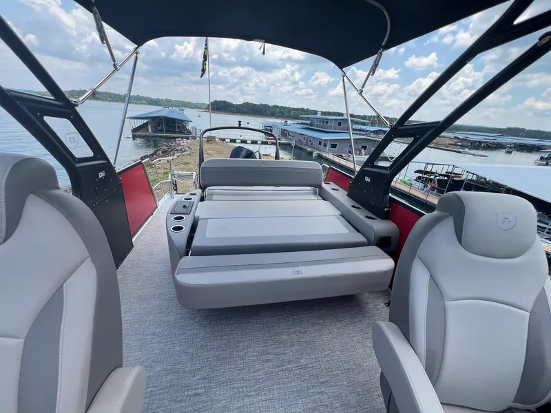 Slide: The Image of 2024 Premier 250 SunSation RF boat interior with seating and lake view. - 7