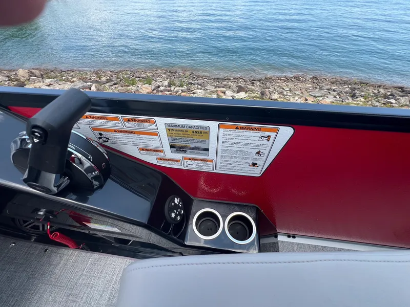 Slide: The Image of 2024 Premier 250 SunSation RF boat interior with control panel and cup holders. - 8