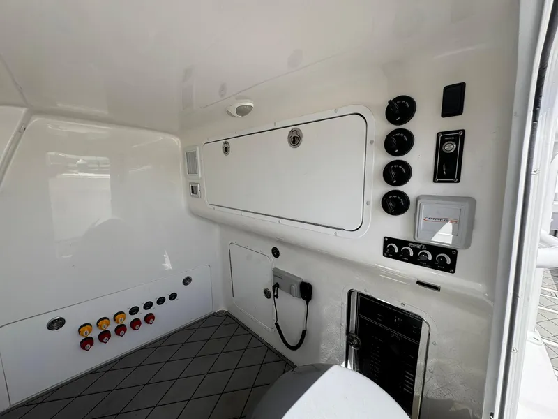 Slide: The Image of Interior control panel of 2022 Invincible 46 Catamaran with various switches and gauges. - 11