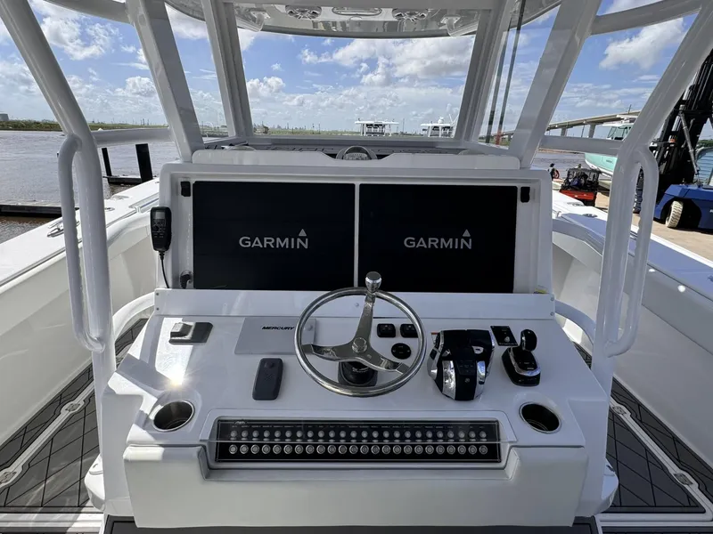 Slide: The Image of Invincible 46 Catamaran 2022 helm with Garmin displays and steering wheel. - 12