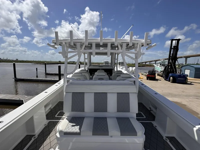 Slide: The Image of Invincible 46 Catamaran 2022 docked, showcasing spacious seating and sleek design under a clear sky. - 14
