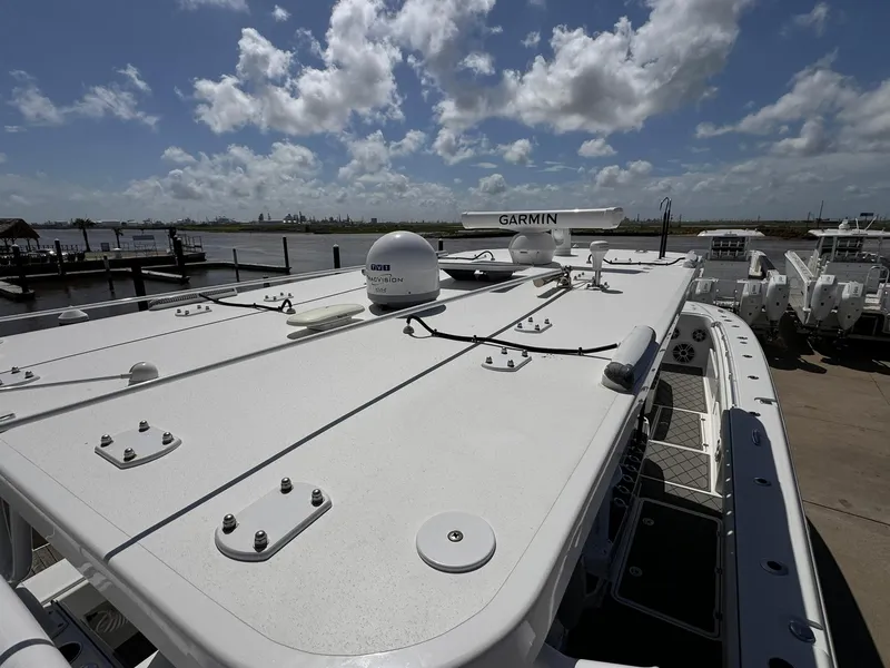 Slide: The Image of Invincible 46 Catamaran 2022 docked under a cloudy sky, showcasing its sleek design. - 16