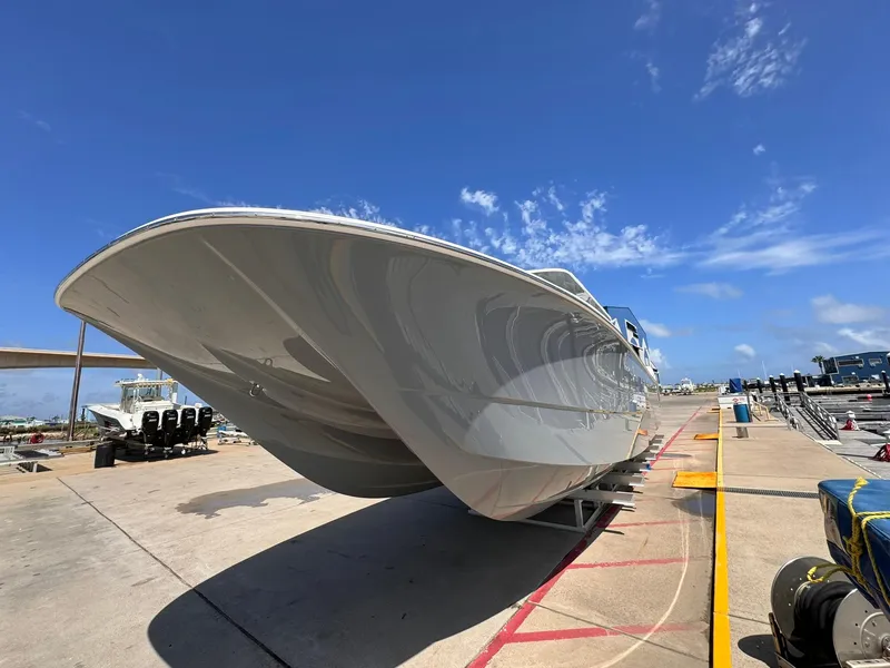Slide: The Image of 2022 Invincible 46 Catamaran on dock under clear blue sky. - 2