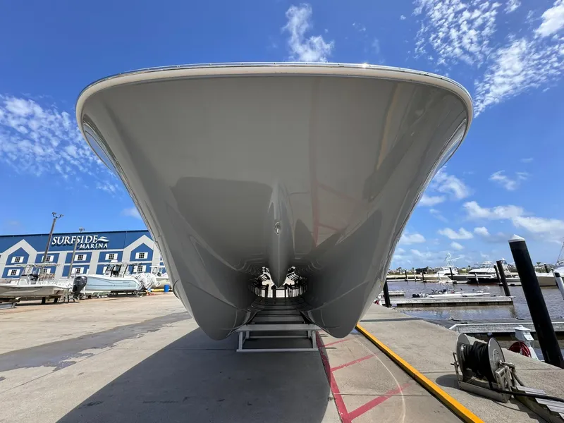 Slide: The Image of 2022 Invincible 46 Catamaran at marina, under clear blue sky. - 3