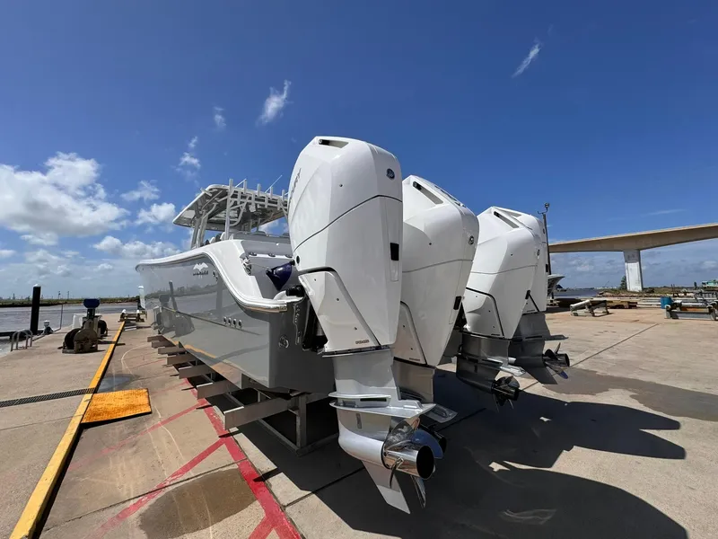 Slide: The Image of 2022 Invincible 46 Catamaran with powerful outboard engines on a sunny dock. - 5