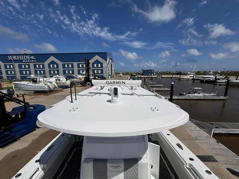 Slide: The Image of Invincible 46 Catamaran 2022 at Surfside Marina, featuring Garmin equipment, docked under blue skies. - 7