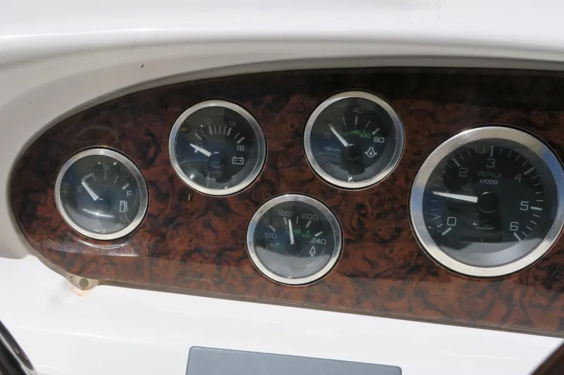 Slide: The Image of Dashboard gauges of a 2002 Sea Ray 400 Sedan Bridge boat. - 12