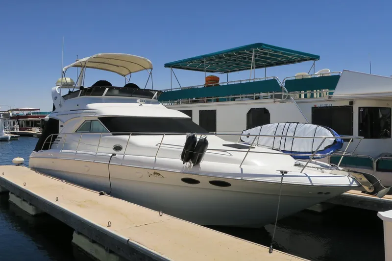 Slide: The Image of 2002 Sea Ray 400 Sedan Bridge yacht docked at a marina. - 16