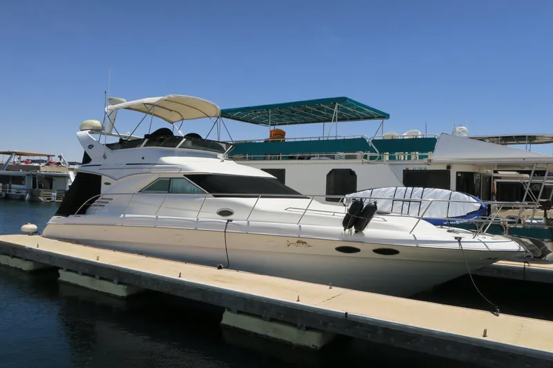 Slide: The Image of 2002 Sea Ray 400 Sedan Bridge yacht docked at marina. - 17