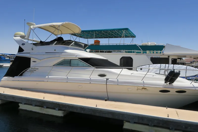 Slide: The Image of 2002 Sea Ray 400 Sedan Bridge yacht docked at marina. - 18