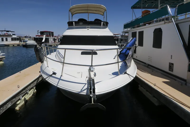 Slide: The Image of 2002 Sea Ray 400 Sedan Bridge docked at a marina. - 19