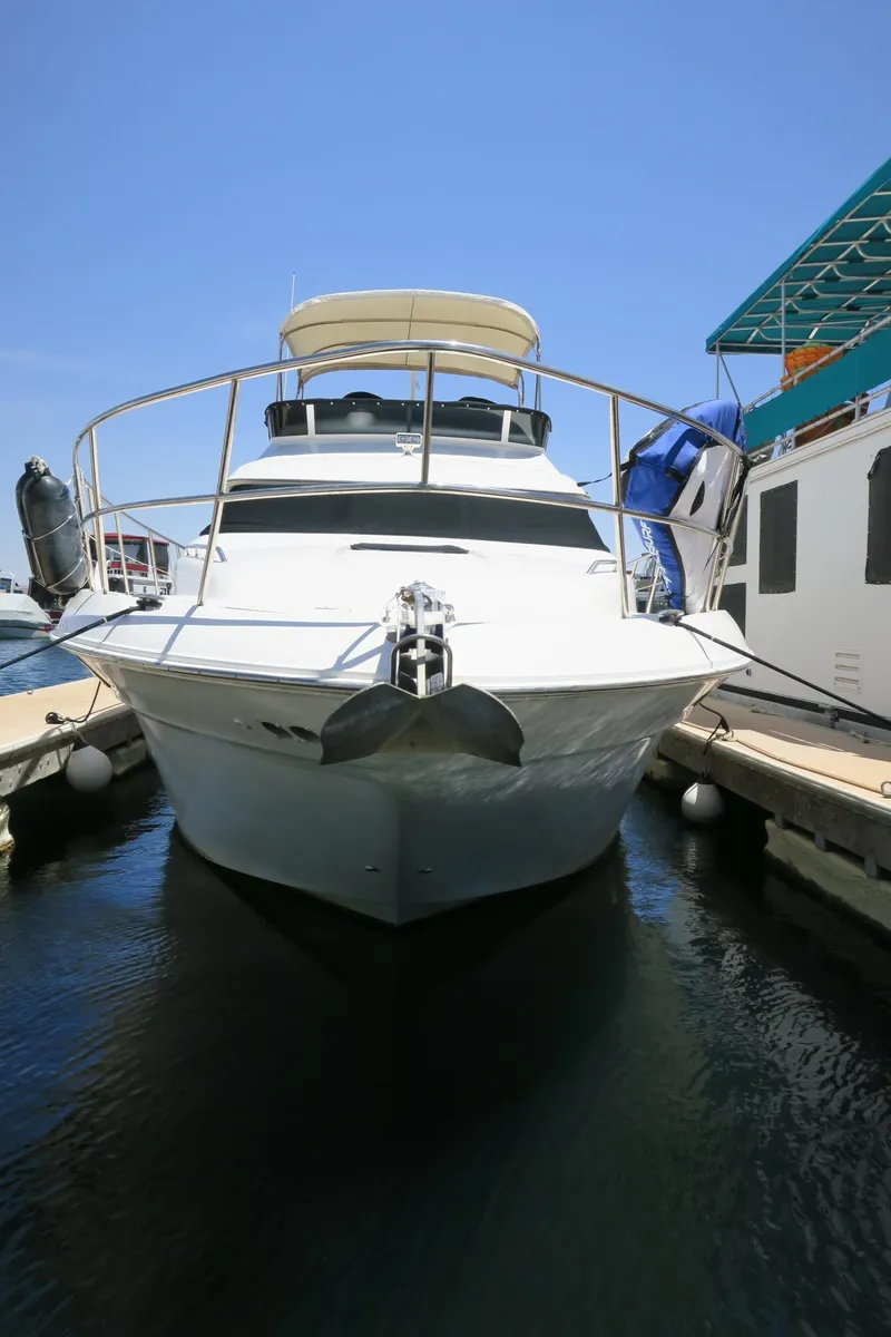 Slide: The Image of 2002 Sea Ray 400 Sedan Bridge yacht docked at marina. - 20