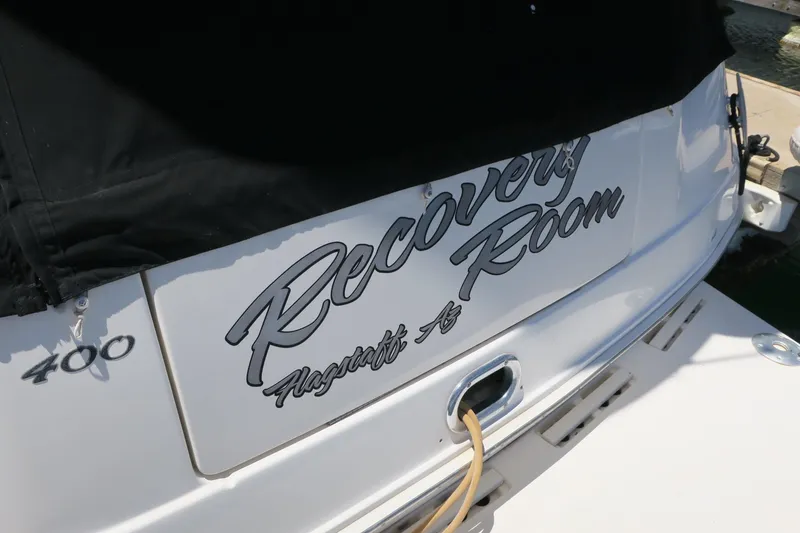 Slide: The Image of 2002 Sea Ray 400 Sedan Bridge boat stern with Recovery Room name. - 25
