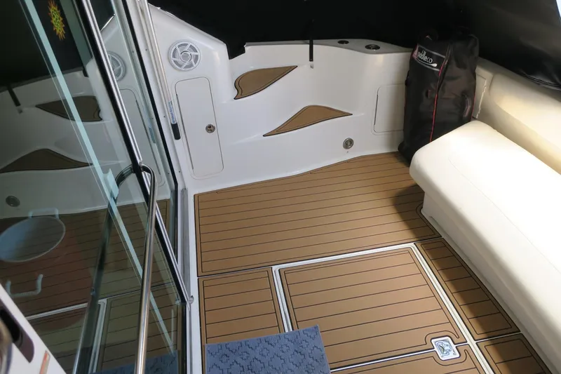 Slide: The Image of Interior deck of 2002 Sea Ray 400 Sedan Bridge with teak flooring and white seating. - 27