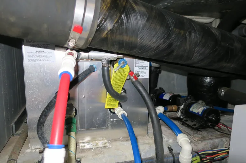 Slide: The Image of Engine compartment of a 2002 Sea Ray 400 Sedan Bridge with various hoses and components. - 35