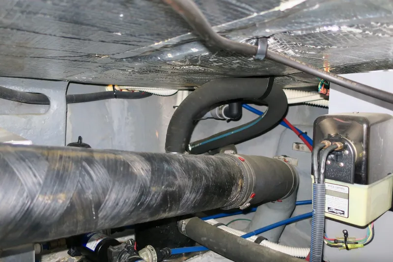 Slide: The Image of Engine compartment of a 2002 Sea Ray 400 Sedan Bridge yacht with various hoses and components. - 36