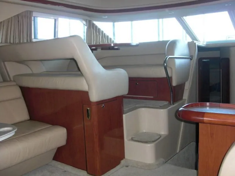 Slide: The Image of Interior of 2002 Sea Ray 400 Sedan Bridge yacht with beige leather seating and wooden accents. - 4