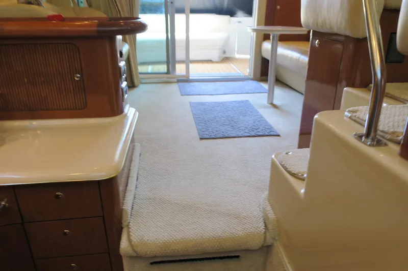 Slide: The Image of Interior of 2002 Sea Ray 400 Sedan Bridge yacht with carpeted flooring and wooden cabinetry. - 43