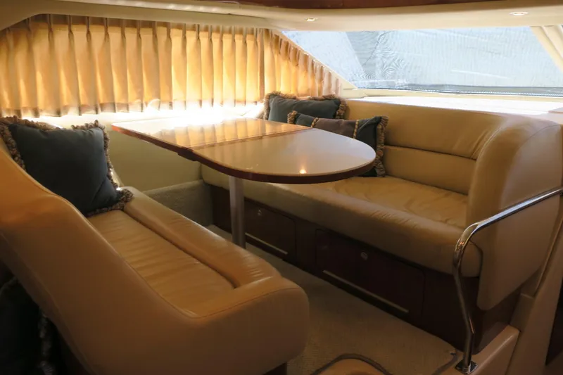Slide: The Image of Interior seating area of a 2002 Sea Ray 400 Sedan Bridge yacht with beige leather upholstery. - 45