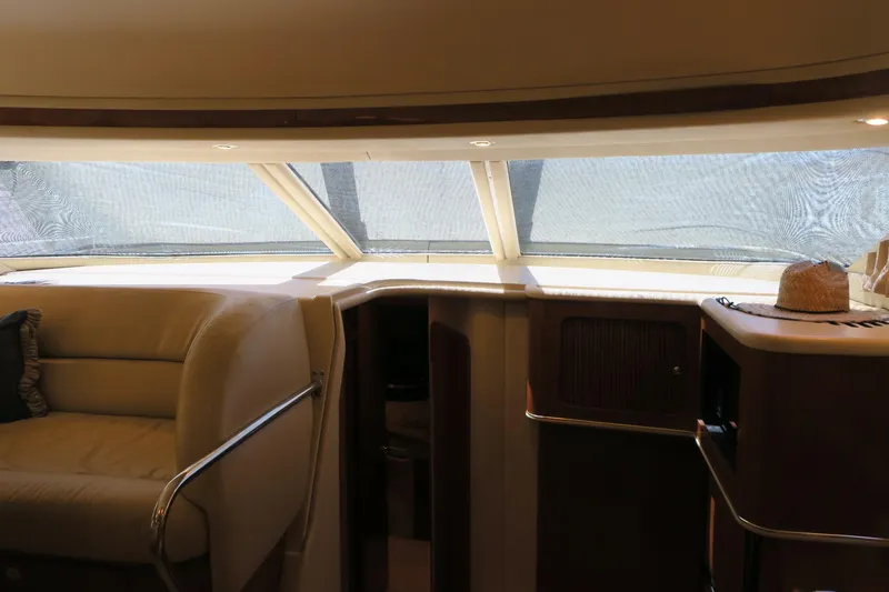 Slide: The Image of Interior of 2002 Sea Ray 400 Sedan Bridge yacht with seating and large windows. - 46