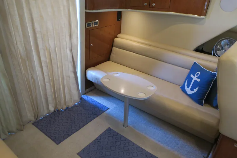 Slide: The Image of Interior of 2002 Sea Ray 400 Sedan Bridge with beige seating and anchor pillow. - 49