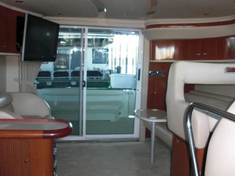 Slide: The Image of Interior of 2002 Sea Ray 400 Sedan Bridge yacht with modern furnishings and sliding glass door. - 7
