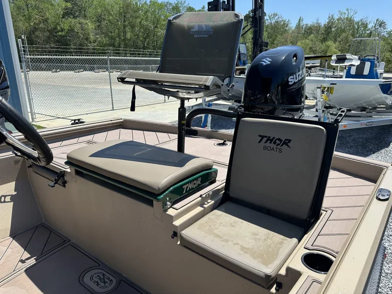 Slide: The Image of 2025 Thor LAKE HAMMER 1900 CC boat interior with Suzuki engine, featuring comfortable seating. - 13