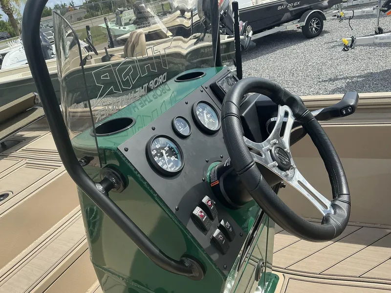 Slide: The Image of Close-up of the control panel and steering wheel of a 2025 Thor LAKE HAMMER 1900 CC boat. - 4