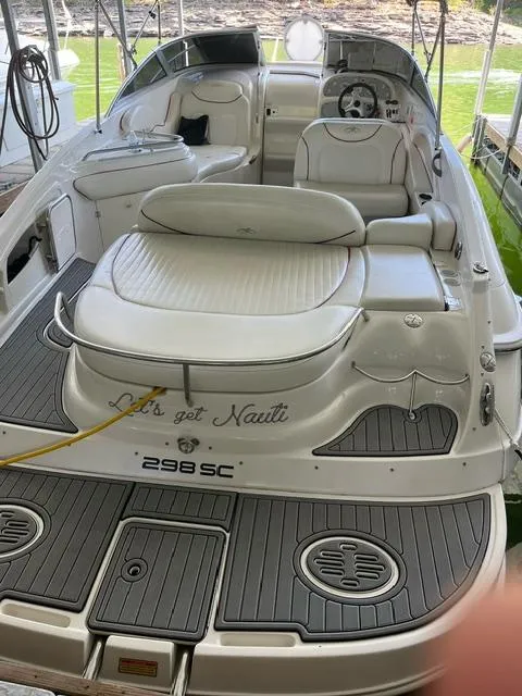 Slide: The Image of 2003 Monterey 298 SC Cruiser boat with white seating and Let's get Nauti text. - 9