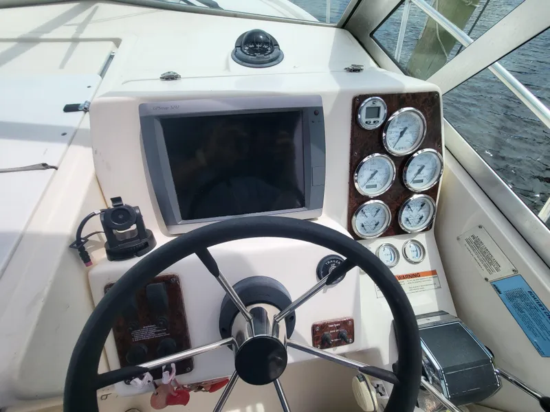 Slide: The Image of 2001 Pursuit 2860 Denali boat dashboard with steering wheel and gauges. - 12