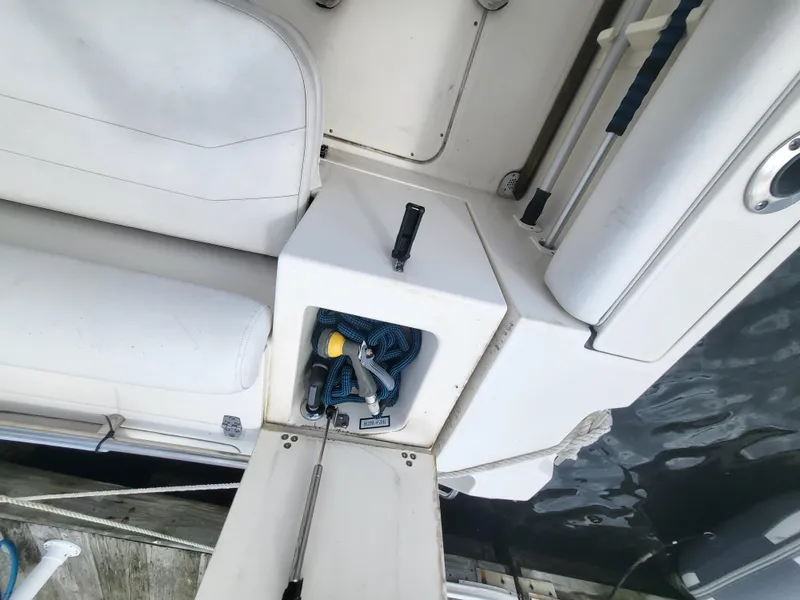 Slide: The Image of 2001 Pursuit 2860 Denali boat interior with storage compartment and seating. - 16