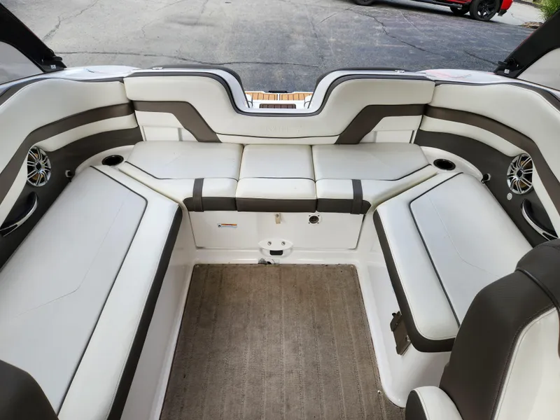 Slide: The Image of 2016 Yamaha Boats 242 Limited S interior with white and gray seating. - 12