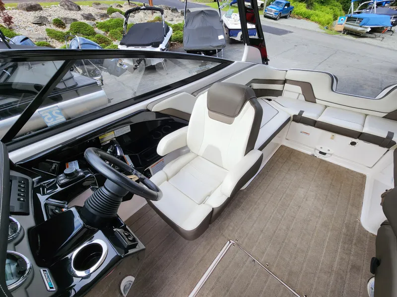 Slide: The Image of 2016 Yamaha Boats 242 Limited S interior with steering wheel and seating area. - 13