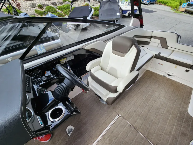Slide: The Image of 2016 Yamaha Boats 242 Limited S interior with steering wheel and seating area. - 14