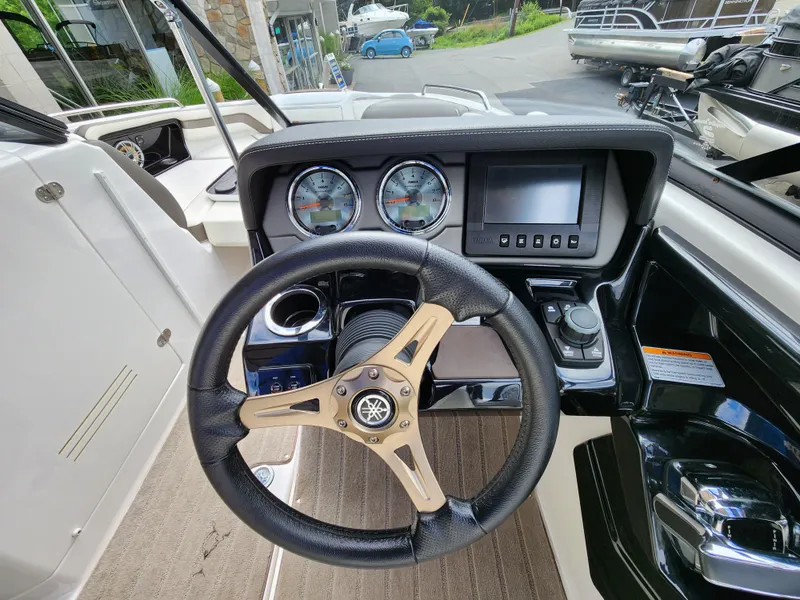 Slide: The Image of 2016 Yamaha Boats 242 Limited S dashboard with steering wheel and gauges. - 15