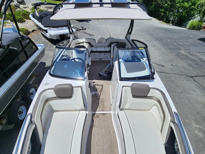 Slide: The Image of 2016 Yamaha Boats 242 Limited S interior with seating and canopy. - 23