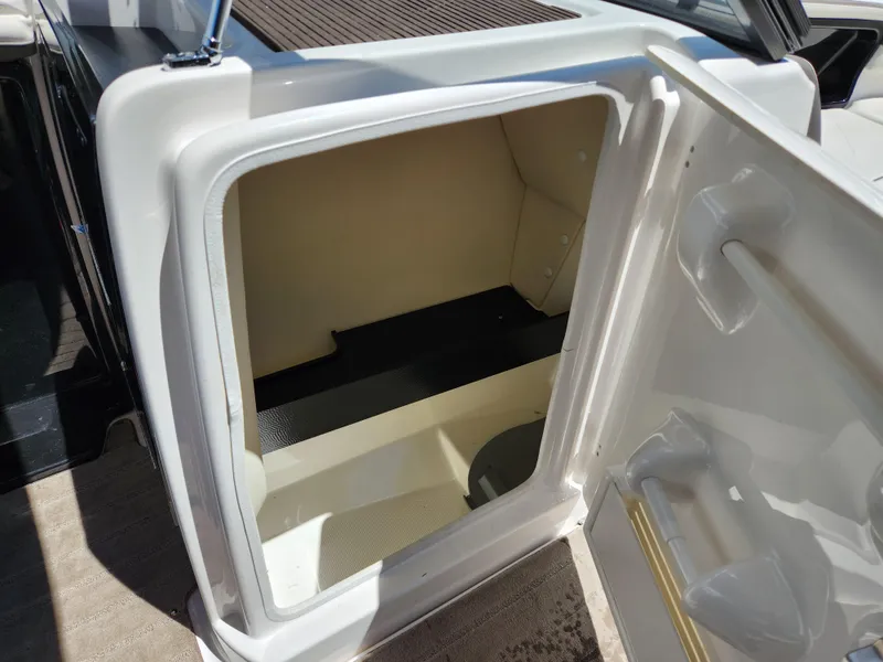 Slide: The Image of Open storage compartment on 2016 Yamaha Boats 242 Limited S. - 25