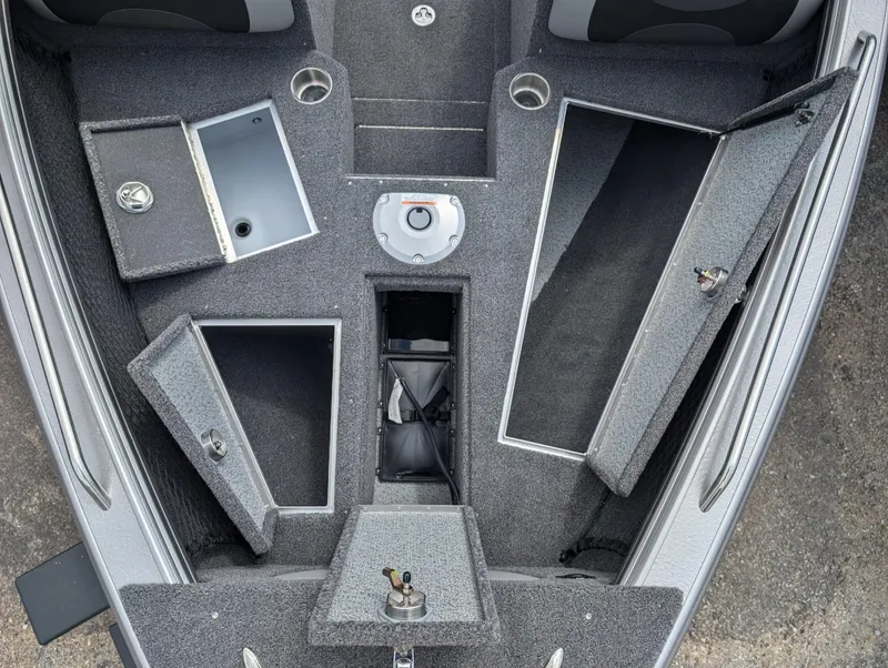 Slide: The Image of 2025 Lund 1975 Tyee boat interior with open storage compartments and seating. - 4