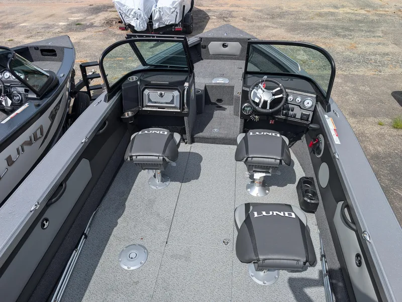 Slide: The Image of Interior of 2025 Lund 1975 Tyee boat with seating and steering console. - 5