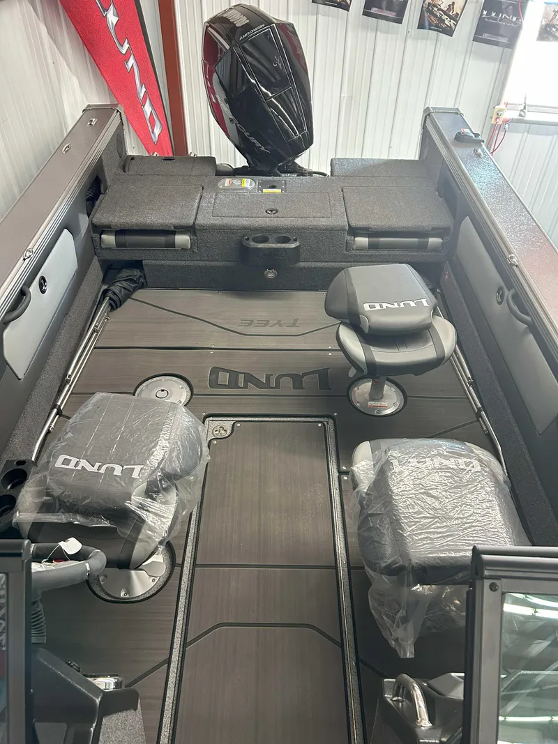Slide: The Image of 2025 Lund 1975 Tyee boat interior with seating and storage compartments. - 4