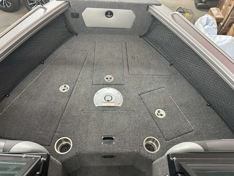 Slide: The Image of 2025 Lund 1975 Tyee boat interior with gray carpet and storage compartments. - 5