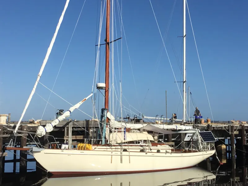 The Image of 1986 Alden Malabar Tribute sailboat docked at a marina under clear blue skies. - 0