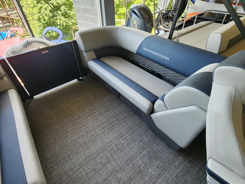 Slide: The Image of 2025 Bennington 22SSR pontoon boat interior with plush seating. - 10