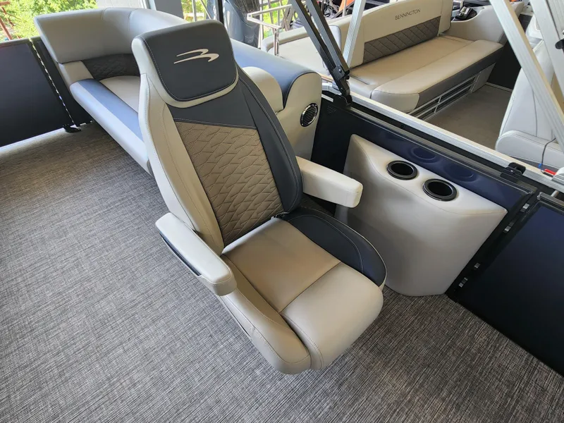 Slide: The Image of 2025 Bennington 22SSR boat interior with luxurious seating and cup holders. - 11